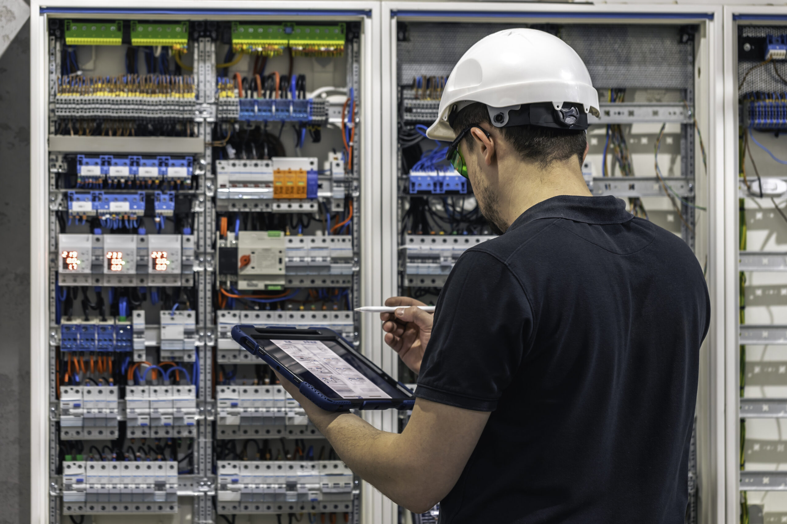 Professional electrical estimator analysing an electrical panel